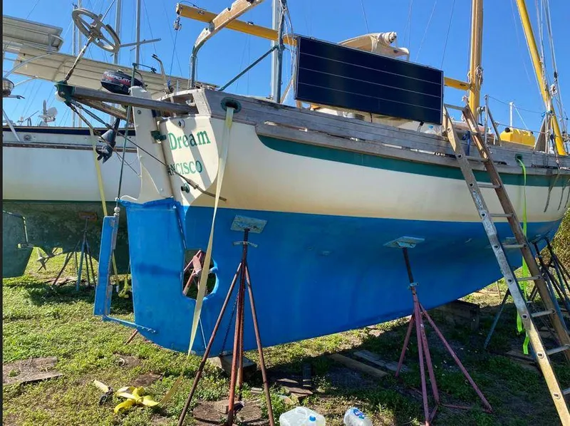 Slide: The Image of Bristol Channel Cutter 28 sailboat, 1990 model, on stands for maintenance. - 4