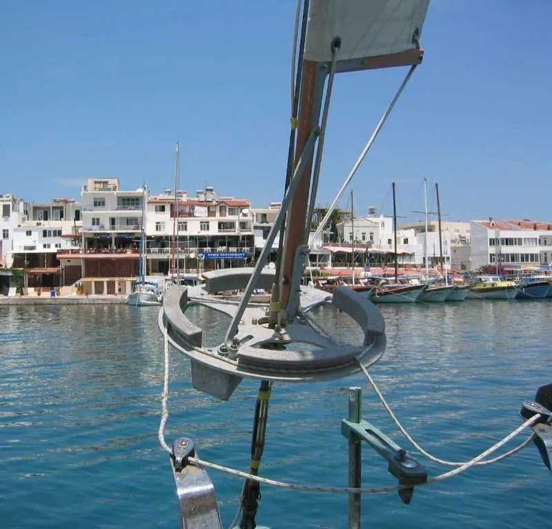 Slide: The Image of Bristol Channel Cutter 28 sailboat in marina, 1990 model, with waterfront buildings in background. - 7