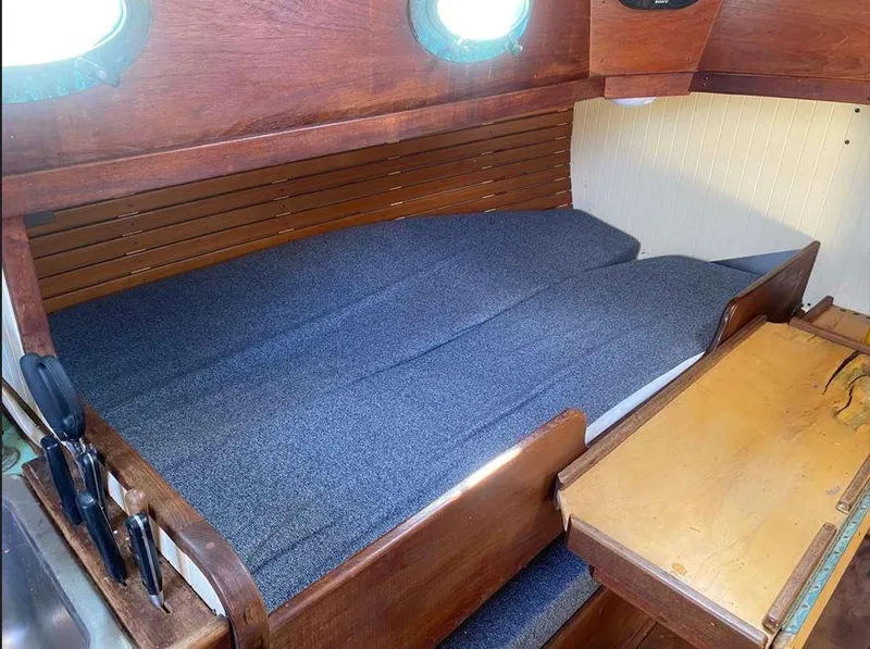 Slide: The Image of Cozy cabin interior of 1990 Bristol Channel Cutter 28 with wooden finish and comfortable bedding. - 9
