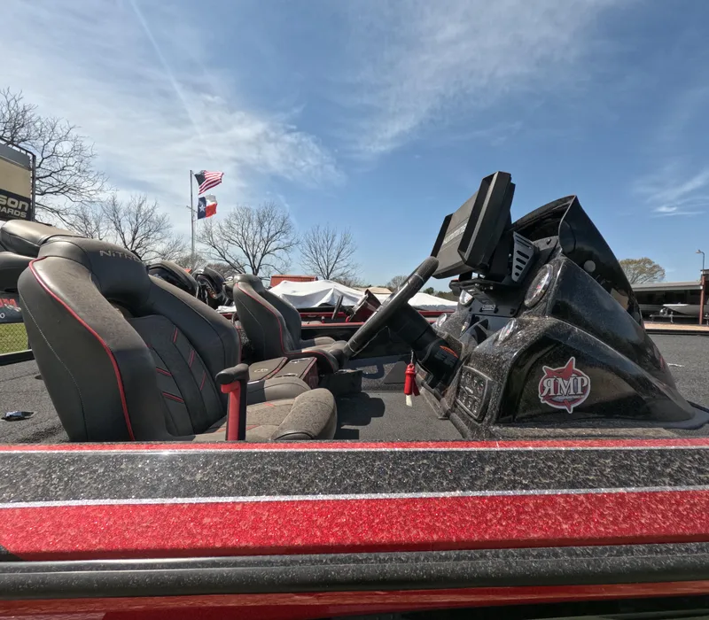 Slide: The Image of 2019 Nitro Z19 boat interior with seats and steering, under clear blue sky. - 14