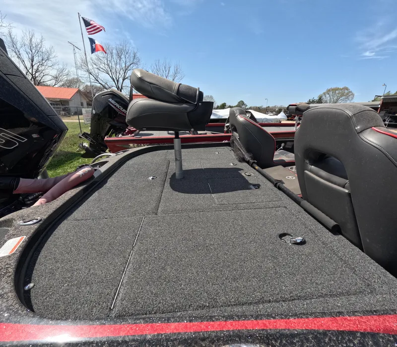 Slide: The Image of 2019 Nitro Z19 boat deck with seating, flags in background, clear sky. - 17