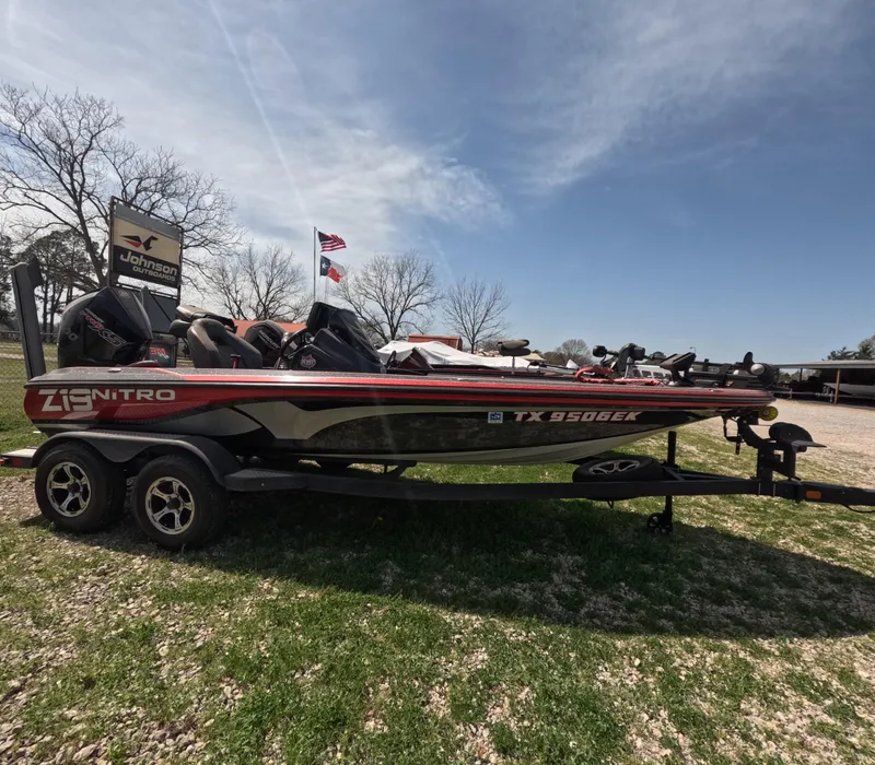 Slide: The Image of 2019 Nitro Z19 boat on trailer, parked outdoors under clear sky. - 2