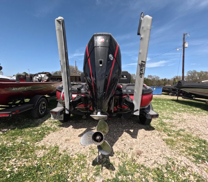 Slide: The Image of 2019 Nitro Z19 boat with motor and dual power poles, parked on grass. - 20