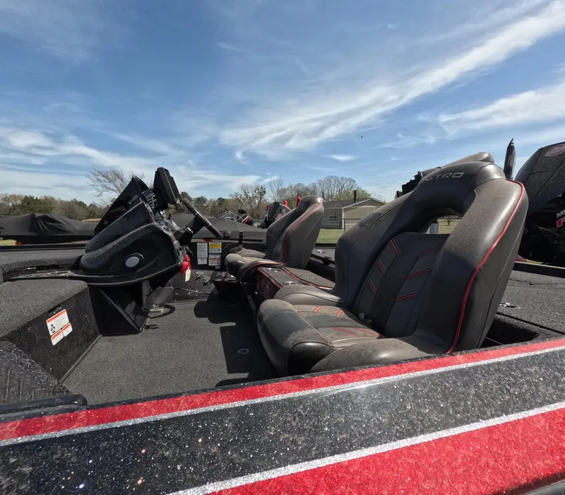 Slide: The Image of 2019 Nitro Z19 boat interior with dual seats under a clear blue sky. - 8
