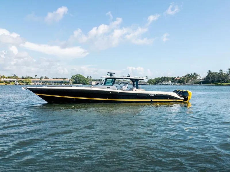Slide: The Image of 2020 HCB 53 Sueños boat on calm water under a clear sky. - 0