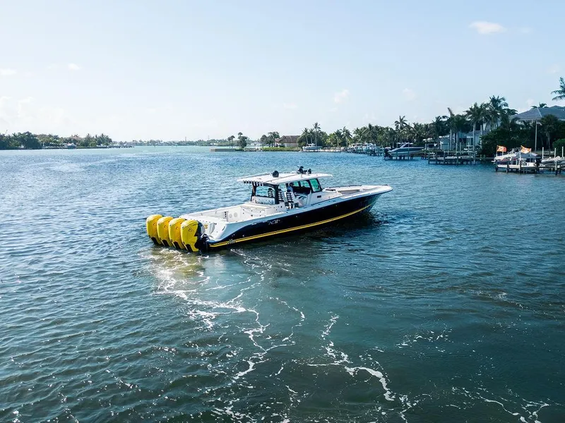 Slide: The Image of 2020 HCB 53 Sueños boat cruising on a sunny, scenic waterway. - 1