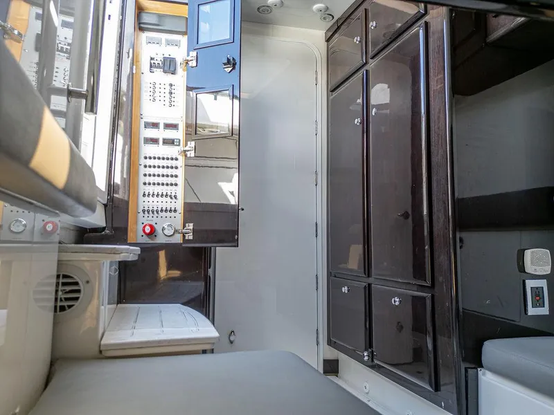 Slide: The Image of Interior of 2020 HCB 53 Sueños boat, featuring control panels and storage cabinets. - 11