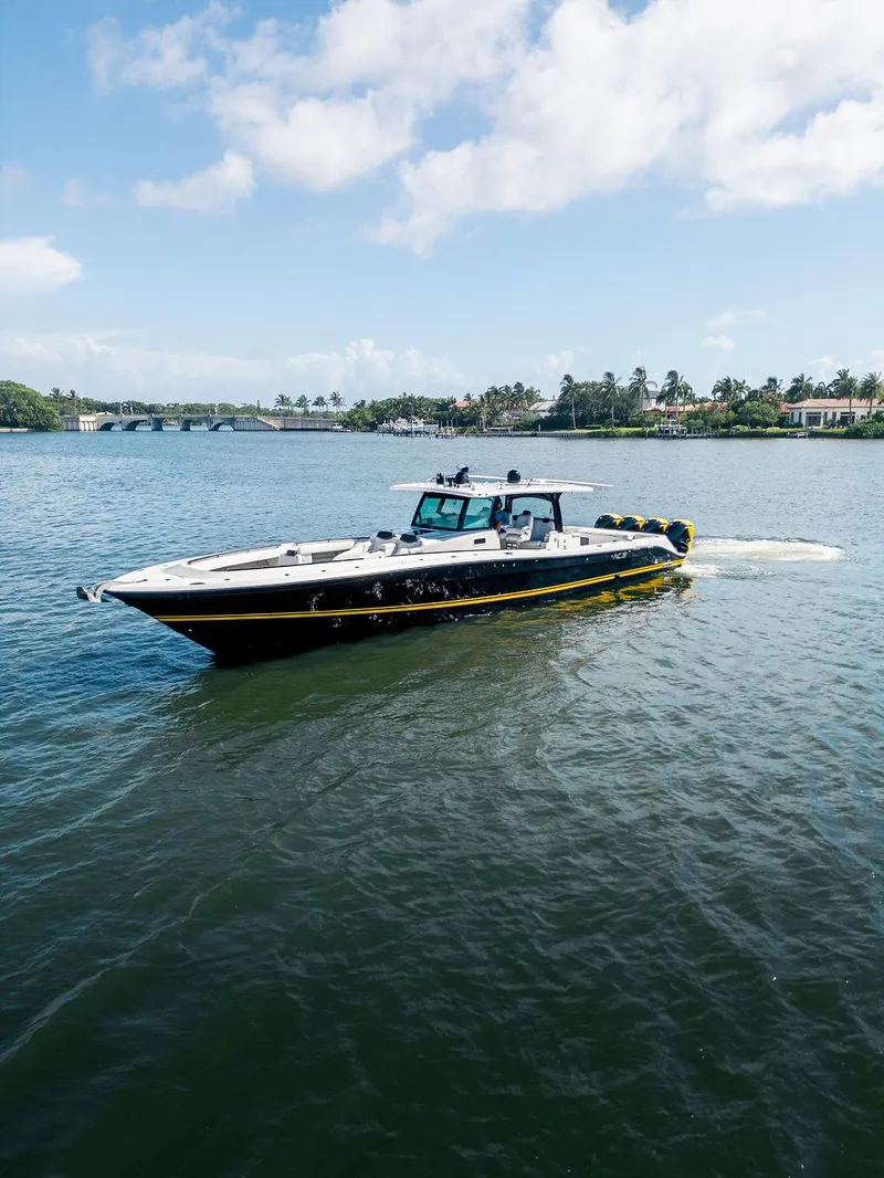 Slide: The Image of 2020 HCB 53 Sueños boat cruising on a sunny day, surrounded by calm waters. - 12