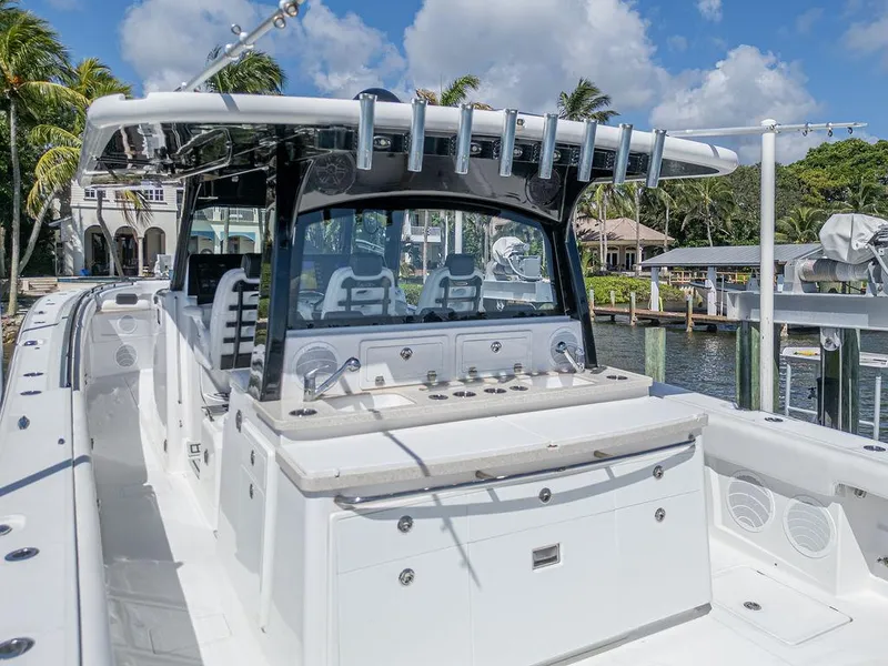 Slide: The Image of 2020 HCB 53 Sueños boat with sleek design, docked near waterfront homes. - 15