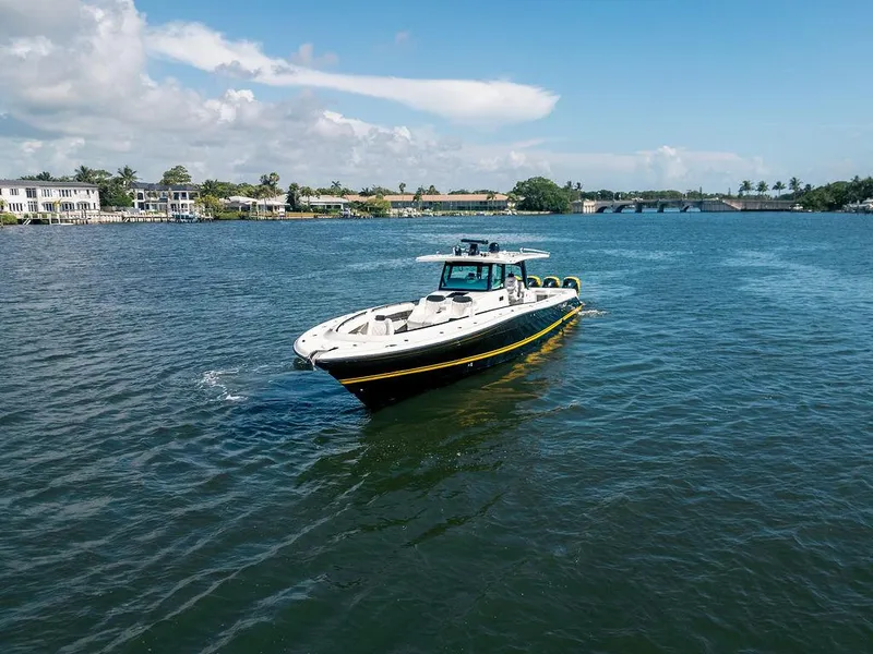 Slide: The Image of 2020 HCB 53 Sueños boat cruising on a sunny day in a scenic waterway. - 16