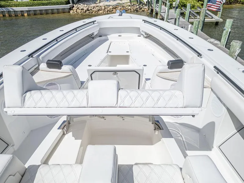 Slide: The Image of 2020 HCB 53 Sueños boat interior with luxurious white seating and sleek design. - 17