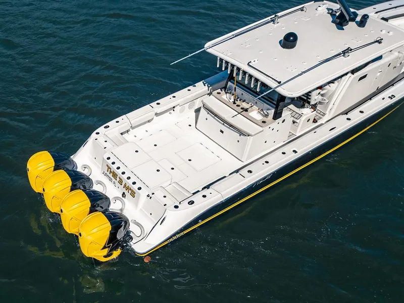 Slide: The Image of 2020 HCB 53 Sueños boat with four yellow outboard engines on water. - 21