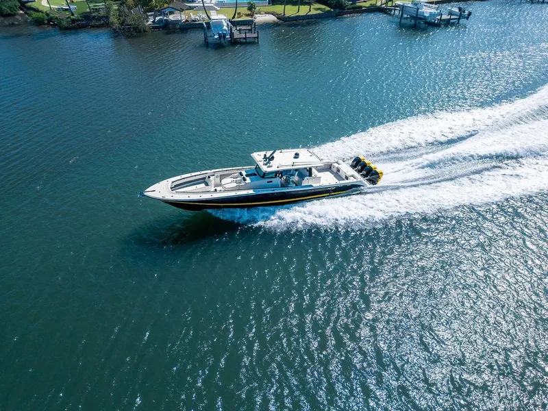 Slide: The Image of 2020 HCB 53 Sueños boat cruising on a sunny day in a scenic waterway. - 22