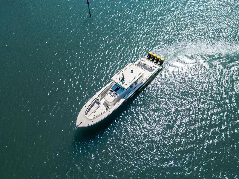Slide: The Image of Aerial view of 2020 HCB 53 Sueños boat cruising on clear blue water. - 23