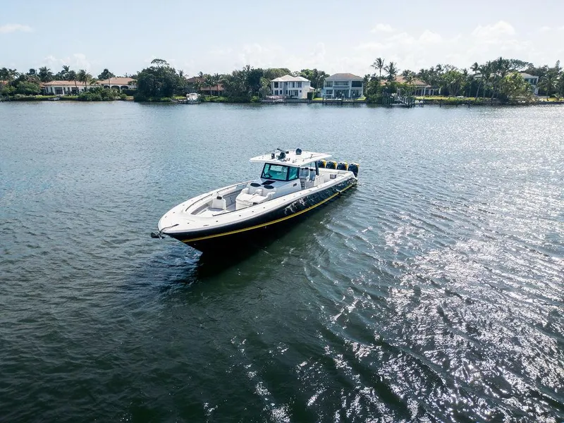 Slide: The Image of 2020 HCB 53 Sueños boat cruising on a sunny, tranquil waterway. - 3