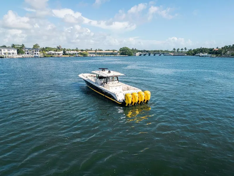 Slide: The Image of 2020 HCB 53 Sueños boat with multiple engines on a calm waterway. - 30