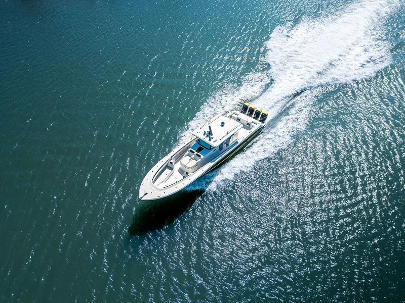 Slide: The Image of Aerial view of 2020 HCB 53 Sueños boat cruising on open water. - 33