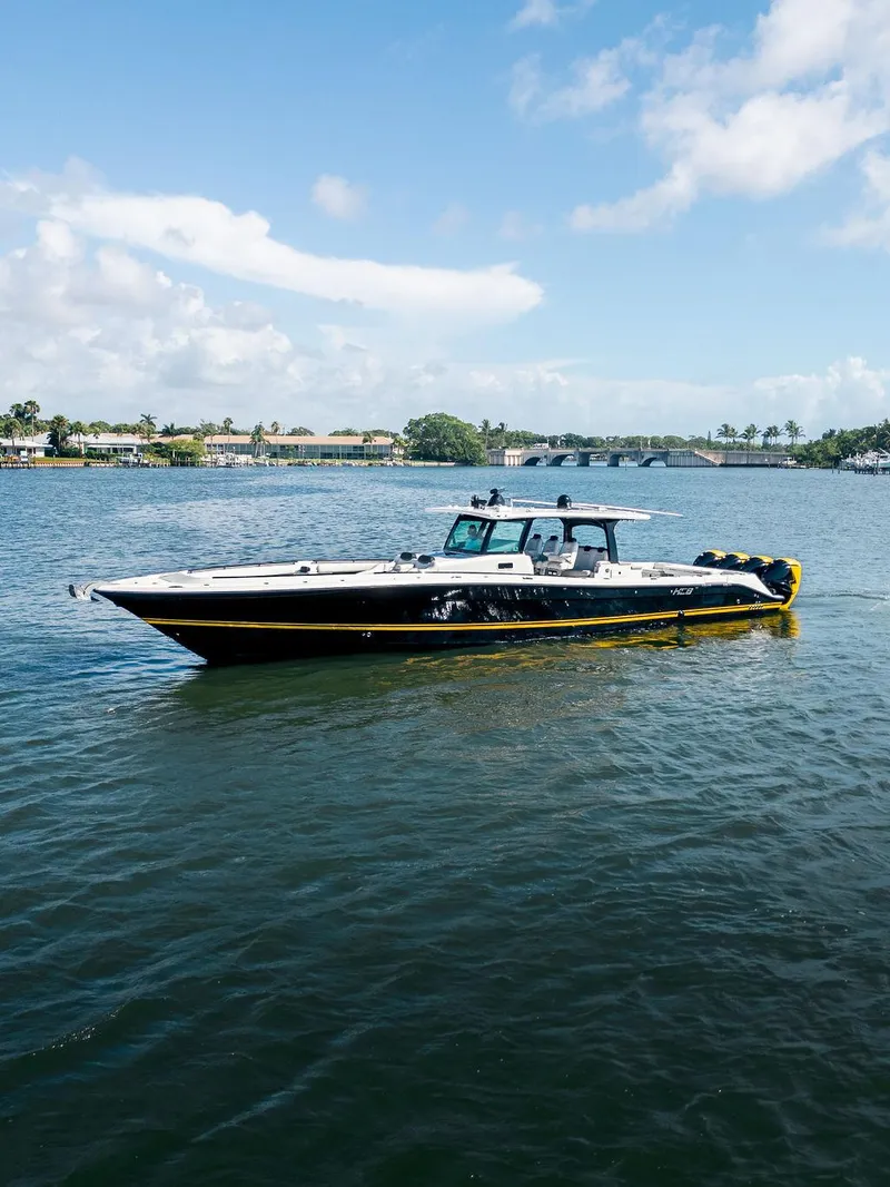 Slide: The Image of 2020 HCB 53 Sueños boat on calm water under a partly cloudy sky. - 37