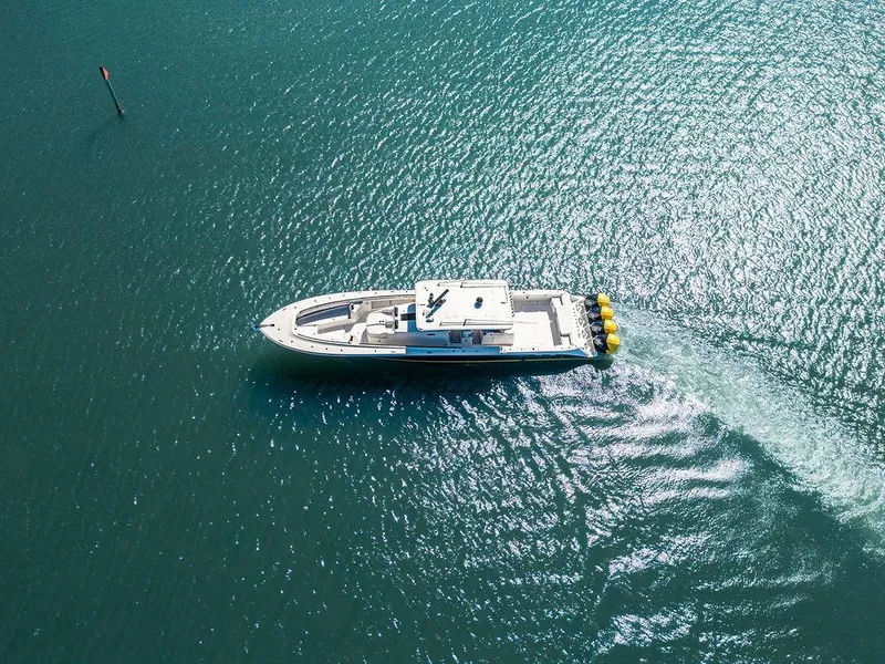 Slide: The Image of Aerial view of 2020 HCB 53 Sueños boat cruising on clear blue water. - 38