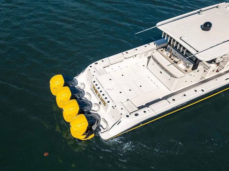 Slide: The Image of 2020 HCB 53 Sueños boat with four yellow outboard motors on water. - 43