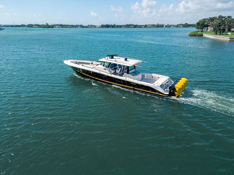 Slide: The Image of 2020 HCB 53 Sueños boat cruising on a clear blue lake under a sunny sky. - 46