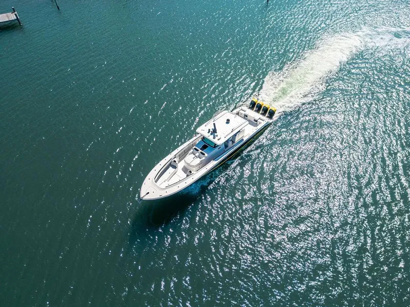 Slide: The Image of Aerial view of 2020 HCB 53 Sueños boat cruising on clear blue water. - 49