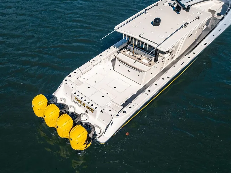 Slide: The Image of 2020 HCB 53 Sueños boat with four yellow outboard engines on water. - 5