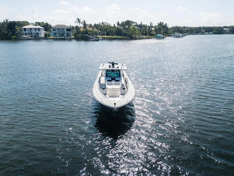 Slide: The Image of 2020 HCB 53 Sueños boat cruising on a sunny, tranquil waterway. - 8