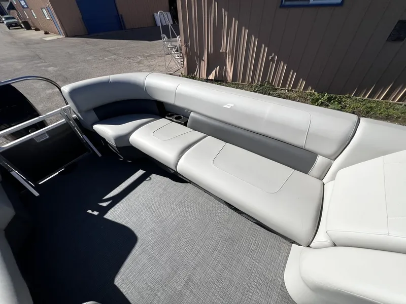 Slide: The Image of The image shows the interior of a 2025 Starcraft LX 22 R boat with gray upholstered seating. - 9