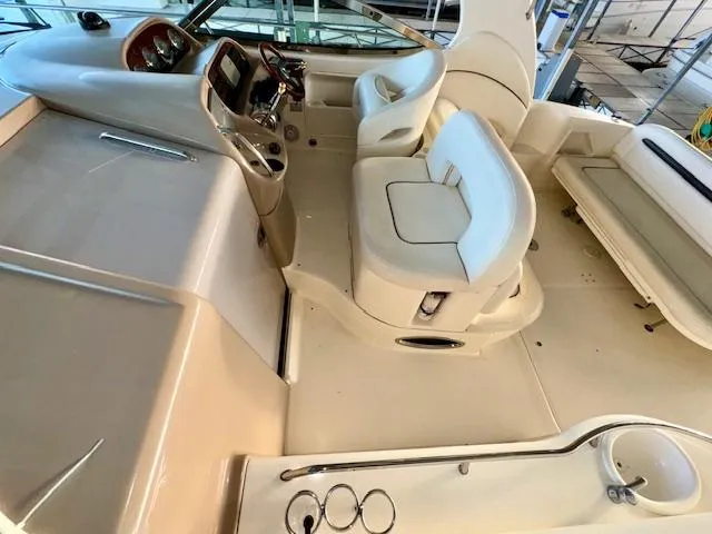 Slide: The Image of 2005 Sea Ray 360 Sundancer boat interior with helm and seating area. - 15