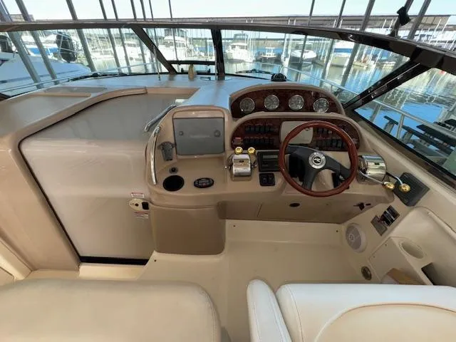 Slide: The Image of 2005 Sea Ray 360 Sundancer helm with steering wheel, gauges, and navigation controls. - 17