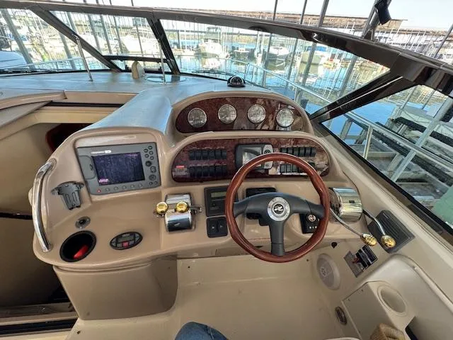 Slide: The Image of Helm of 2005 Sea Ray 360 Sundancer with steering wheel and navigation instruments. - 18
