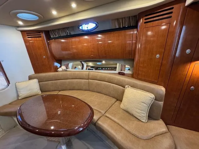 Slide: The Image of Luxurious interior of 2005 Sea Ray 360 Sundancer with plush seating and wooden cabinetry. - 26