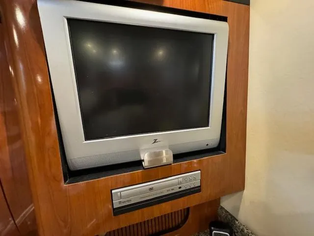 Slide: The Image of 2005 Sea Ray 360 Sundancer interior with built-in TV and DVD player. - 35