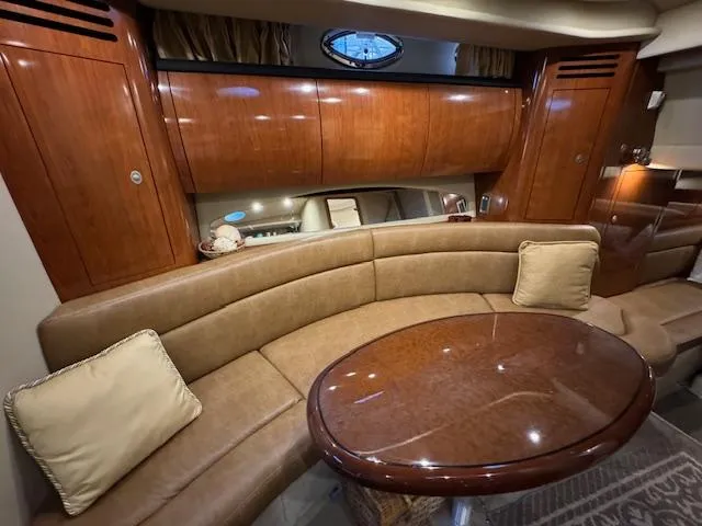 Slide: The Image of Luxurious interior of 2005 Sea Ray 360 Sundancer with curved seating and polished wood table. - 43