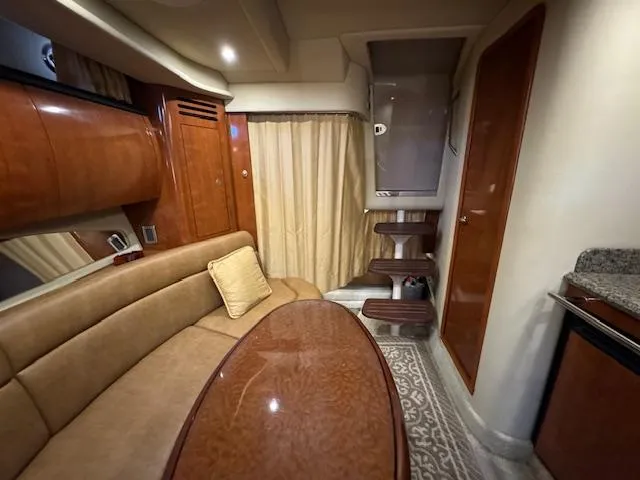 Slide: The Image of 2005 Sea Ray 360 Sundancer interior with plush seating, wooden table, and elegant design. - 45