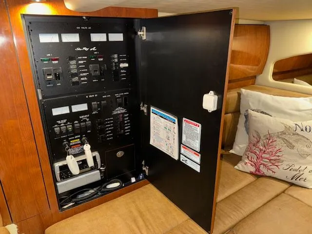 Slide: The Image of Electrical panel inside 2005 Sea Ray 360 Sundancer yacht cabin with control switches and labels. - 48