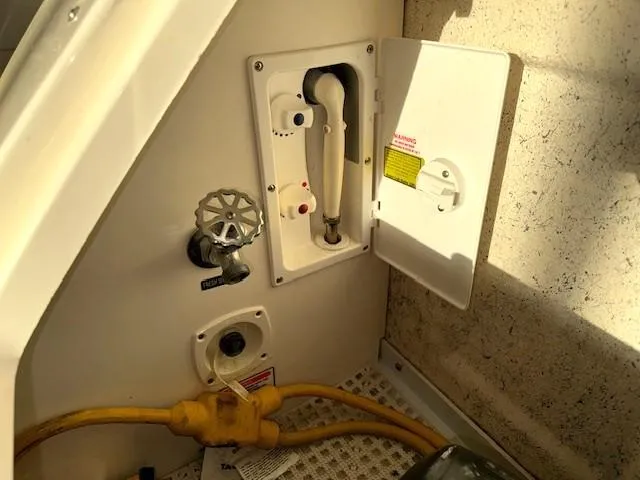 Slide: The Image of 2005 Sea Ray 360 Sundancer boat utility panel with hose and valve. - 7