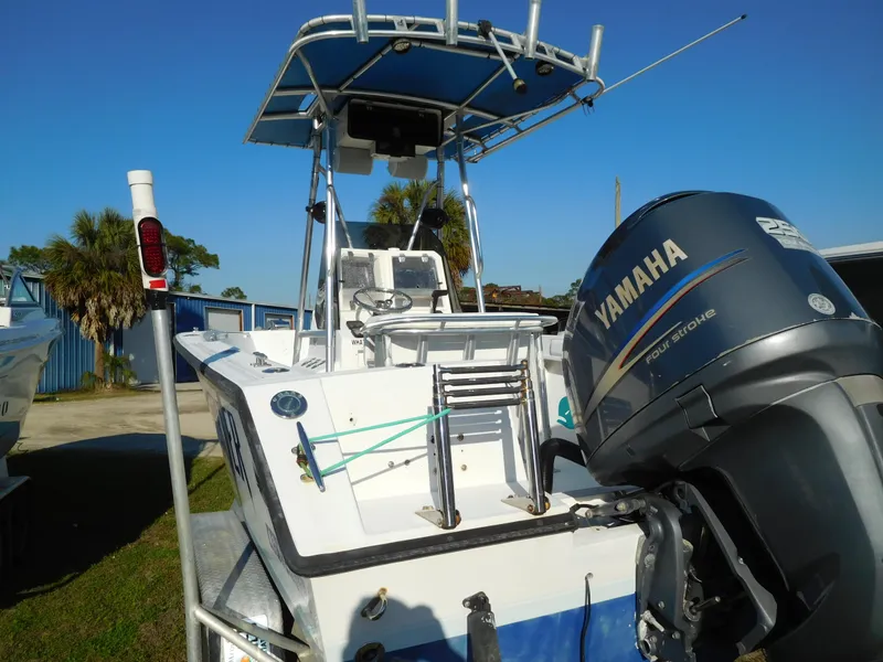 Slide: The Image of 2007 Contender 21 CC boat with Yamaha outboard motor, parked outdoors. - 2