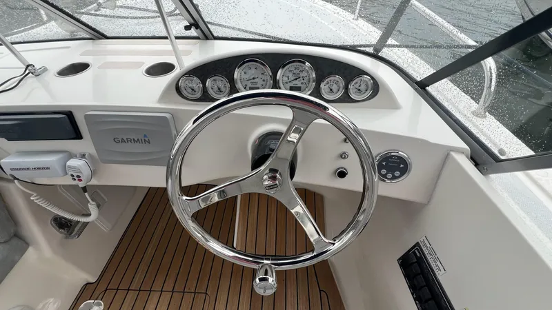 Slide: The Image of Steering wheel and dashboard of 2013 Vanquish 24 Runabout boat with Garmin system. - 5