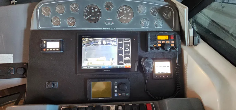 Slide: The Image of Control panel of a 2002 Pursuit 3800 Express boat with navigation instruments. - 12