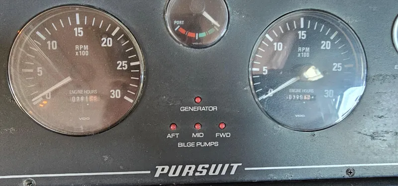 Slide: The Image of Dashboard of a 2002 Pursuit 3800 Express boat with RPM gauges and bilge pump indicators. - 13