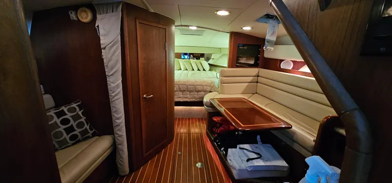Slide: The Image of 2002 Pursuit 3800 Express cabin interior with wood flooring, seating, and bed. - 14