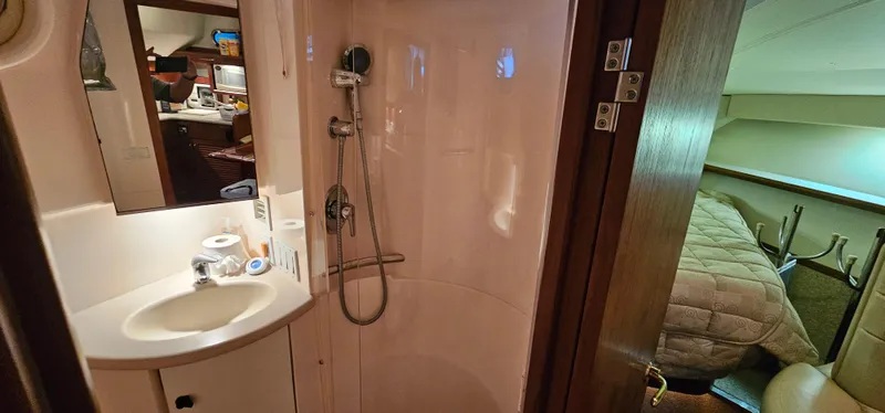 Slide: The Image of 2002 Pursuit 3800 Express yacht interior with shower and cozy cabin. - 17