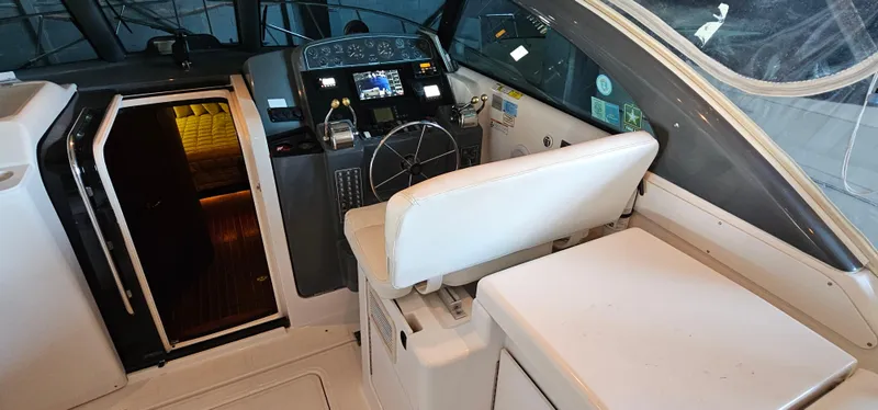 Slide: The Image of 2002 Pursuit 3800 Express boat cockpit with steering wheel and seating area. - 2