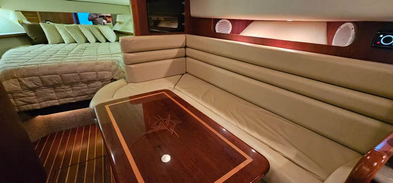 Slide: The Image of Interior of 2002 Pursuit 3800 Express yacht with plush seating and elegant wood table. - 21