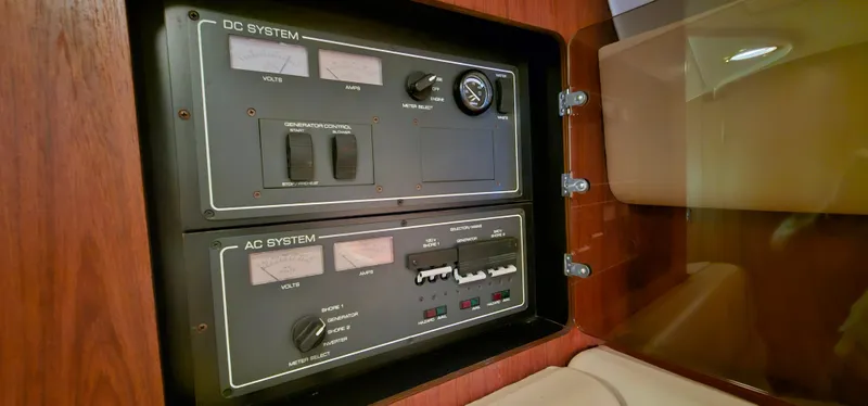Slide: The Image of Electrical panel of a 2002 Pursuit 3800 Express boat, featuring DC and AC systems. - 24