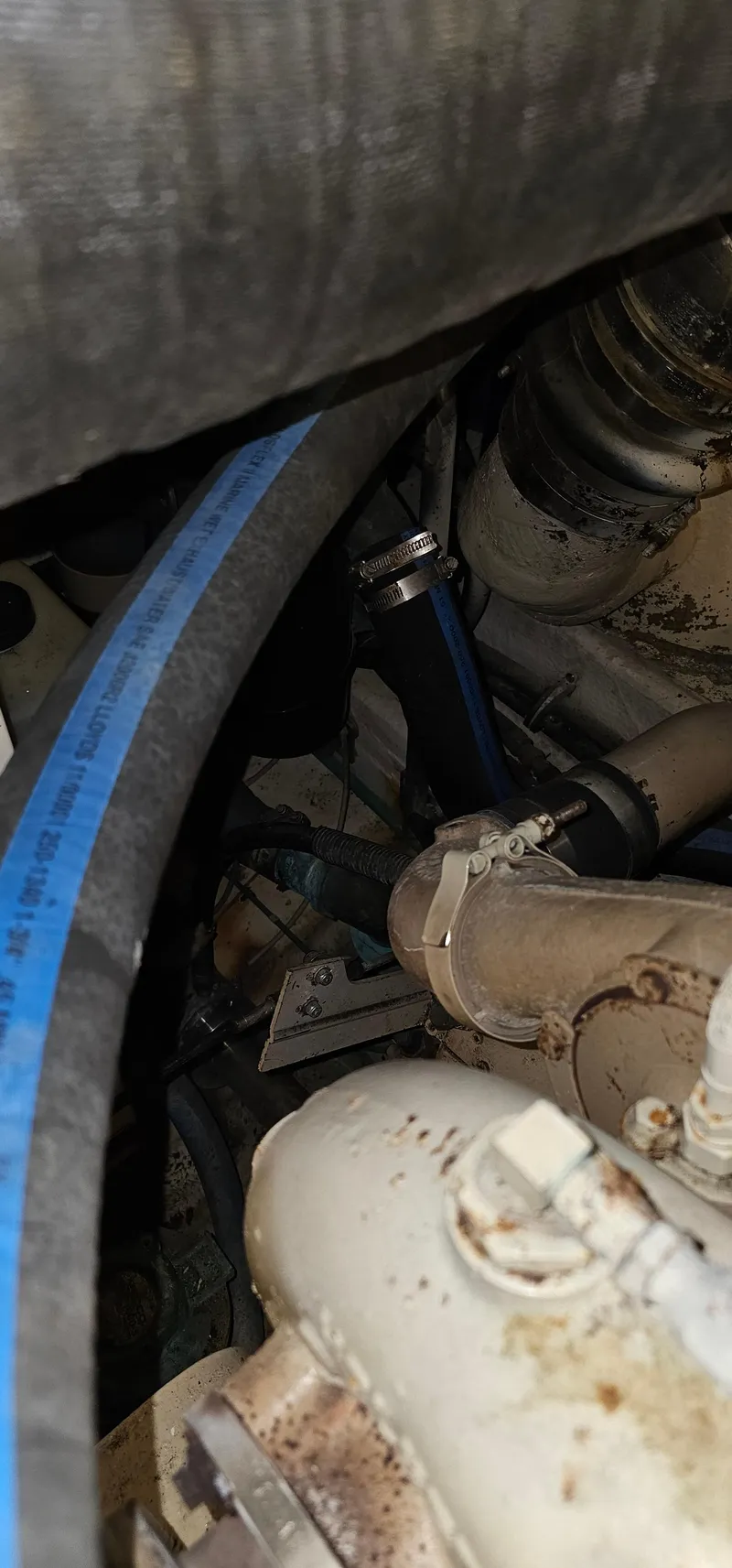 Slide: The Image of Close-up of a 2002 Pursuit 3800 Express engine component with visible hoses and fittings. - 29