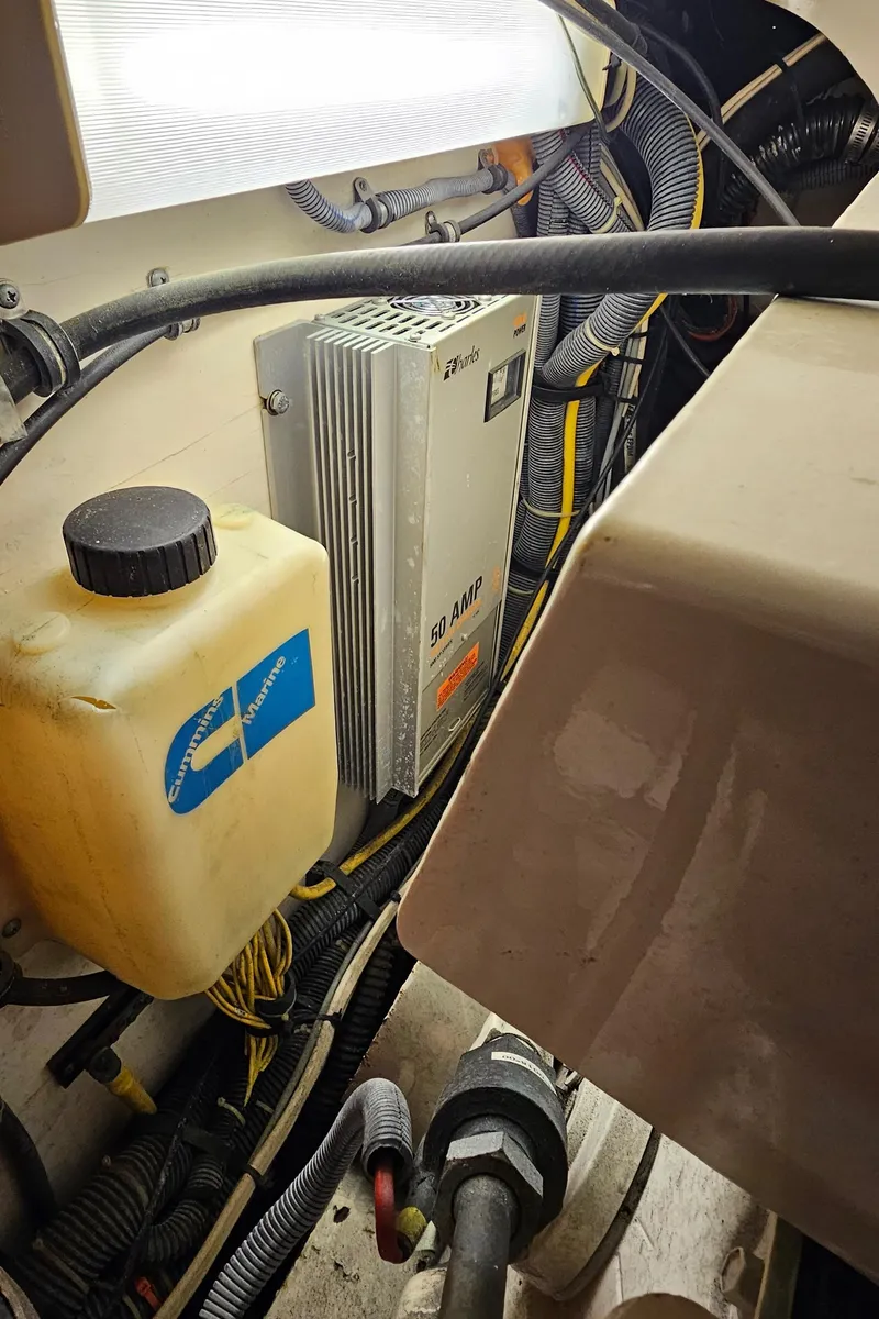 Slide: The Image of Engine compartment of a 2002 Pursuit 3800 Express boat, showing wiring and fluid container. - 31