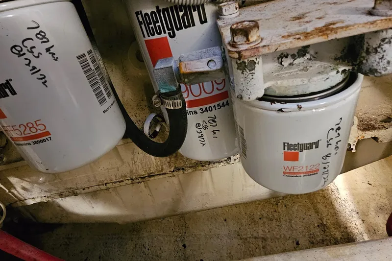 Slide: The Image of Fleetguard filters in a 2002 Pursuit 3800 Express engine compartment. - 32